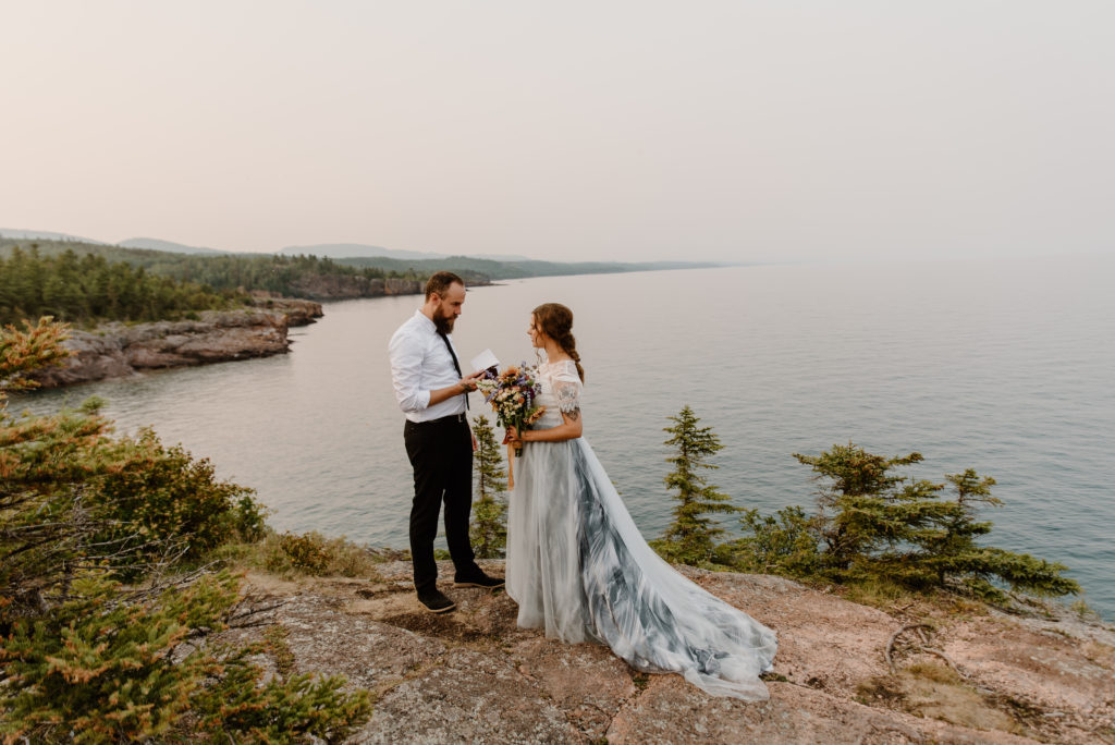 A couple exchanging vows during sunset on the north shore of Lake Superior.